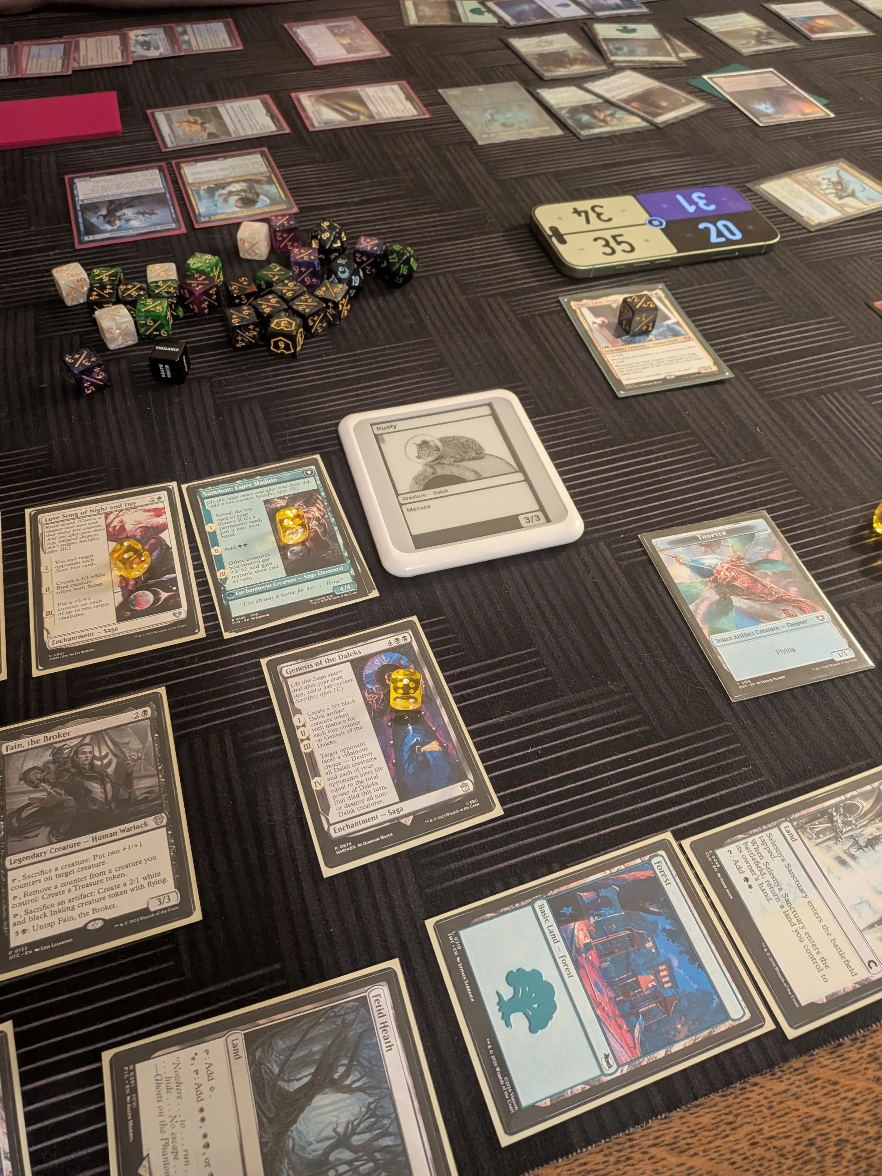 Photo of a Magic: The Gathering game with the e-ink display.